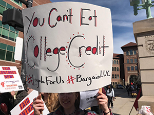 An LUC graduate worker participates in the April 24 walkout. Graduate assistants there claim their stipends pay less than a living wage. Photo credit: LUC Graduate Workers’ Union, SEIU Local 73