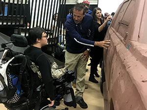 A General Motors representative explains clay modeling techniques to a local student at the Macomb Community College 2018 Auto STEAM Days event.