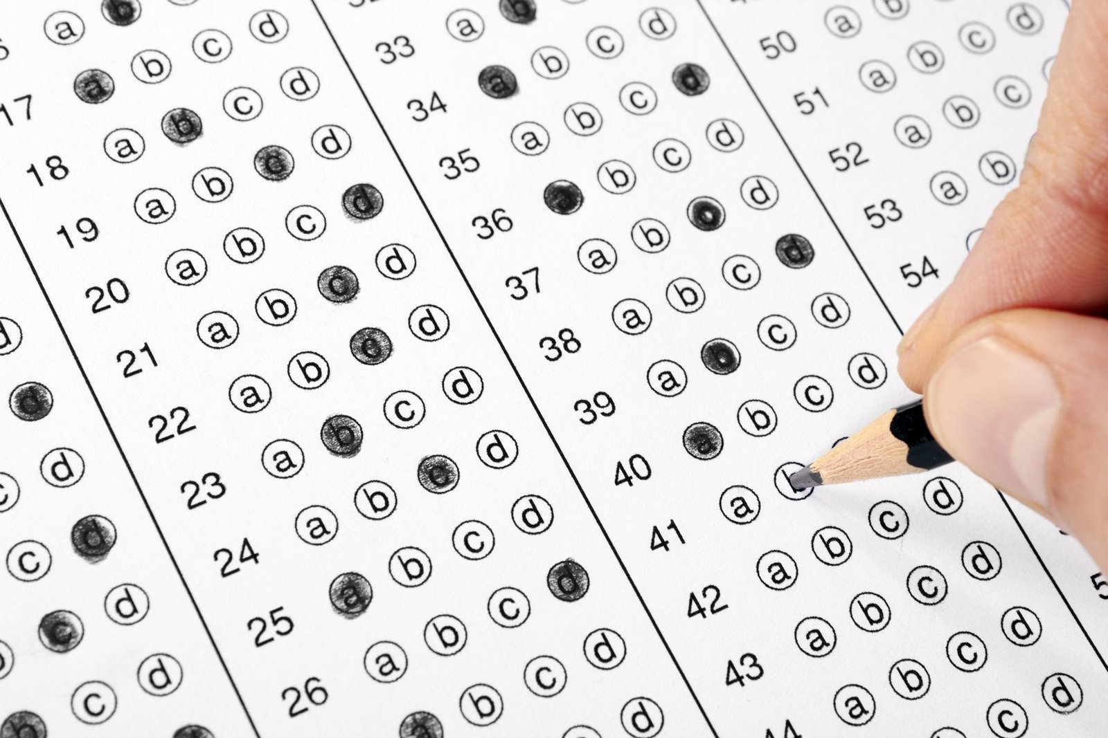Photo of student filling bubble on test answer sheet.