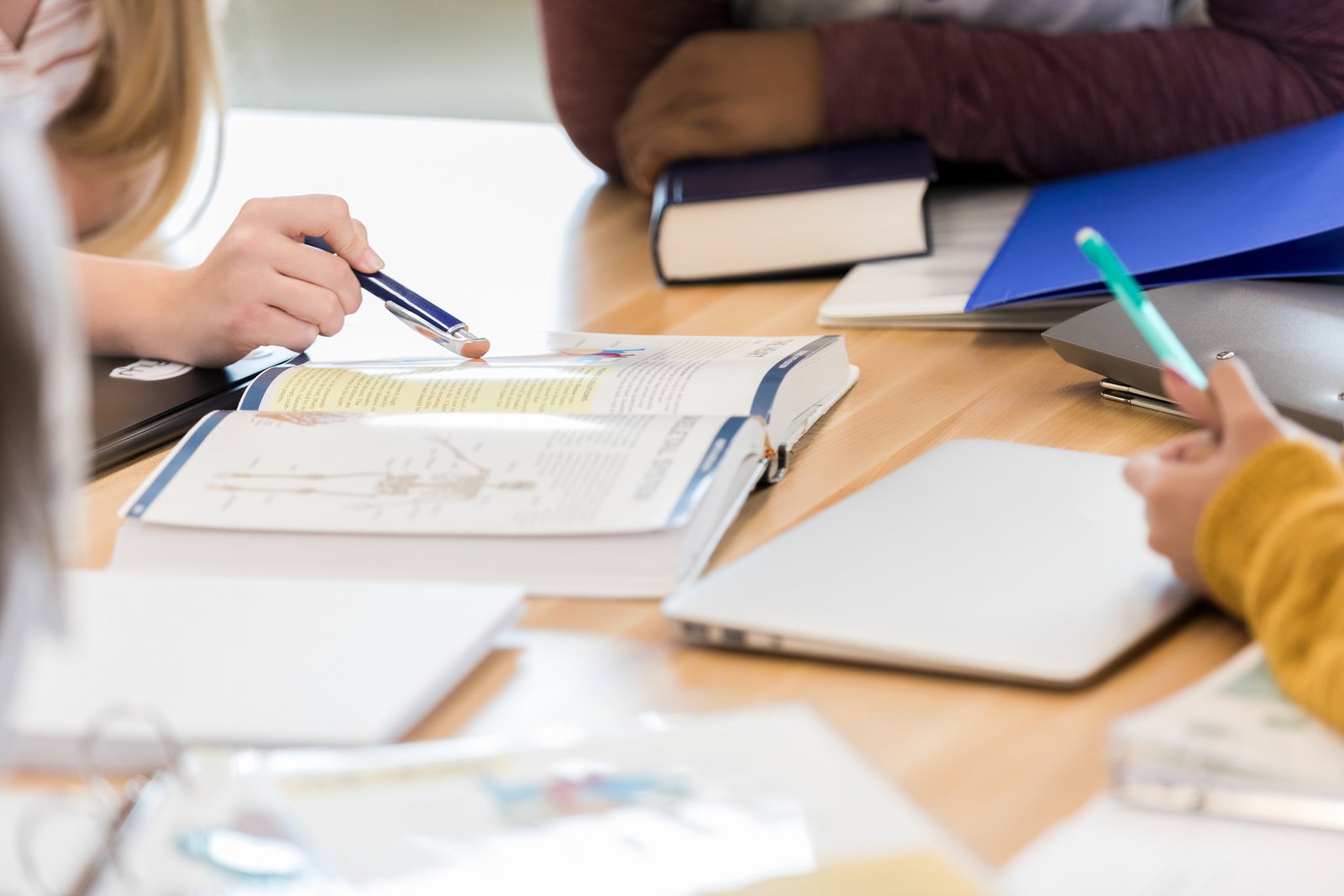 Image of students studying a biology textbook