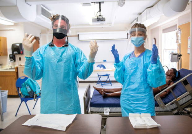 A photo of University of Maine School of Nursing students wearing full personal protective equipment to conduct simulation labs.