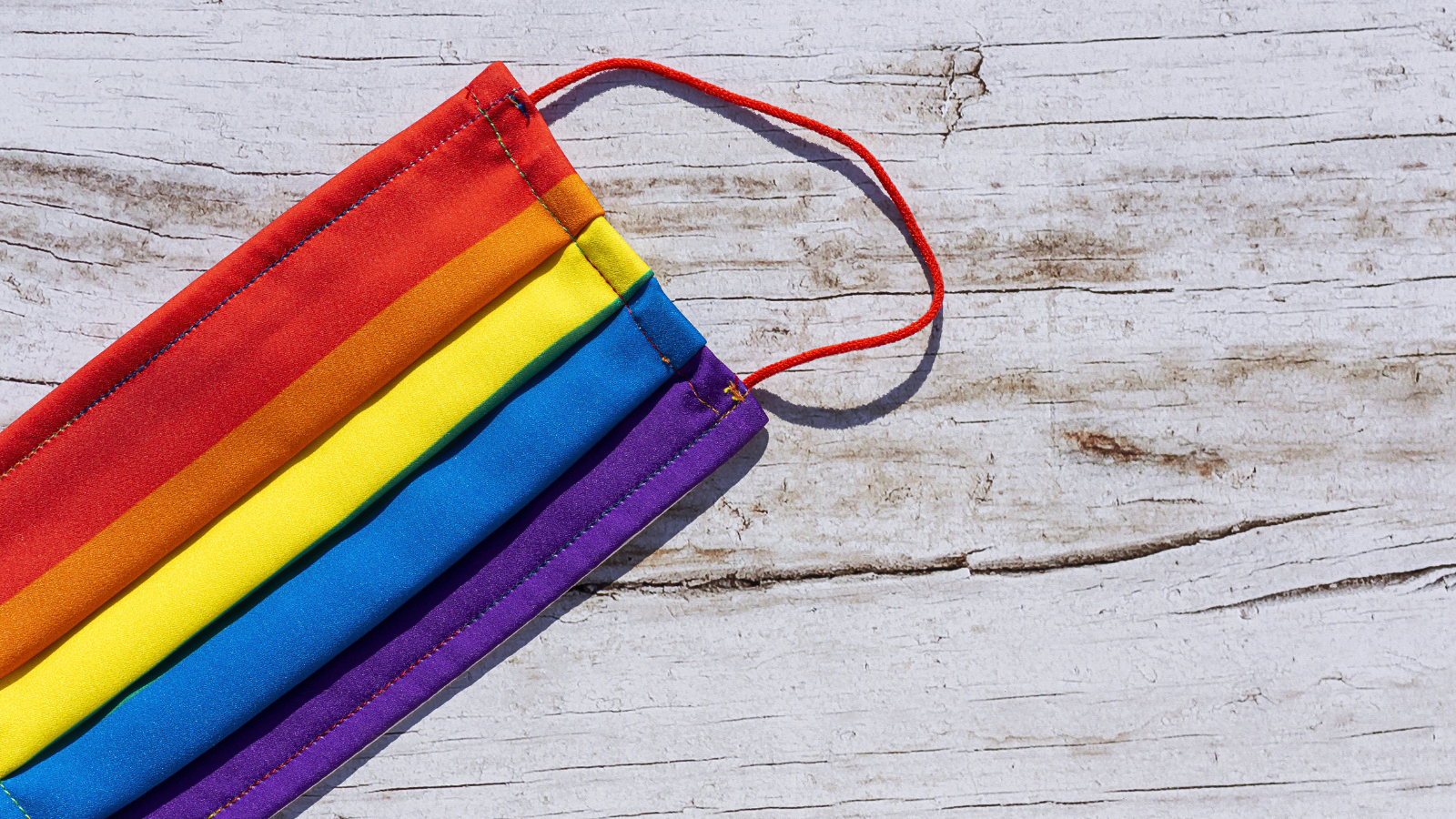 Photo of a face mask in LGBTQ Pride colors.