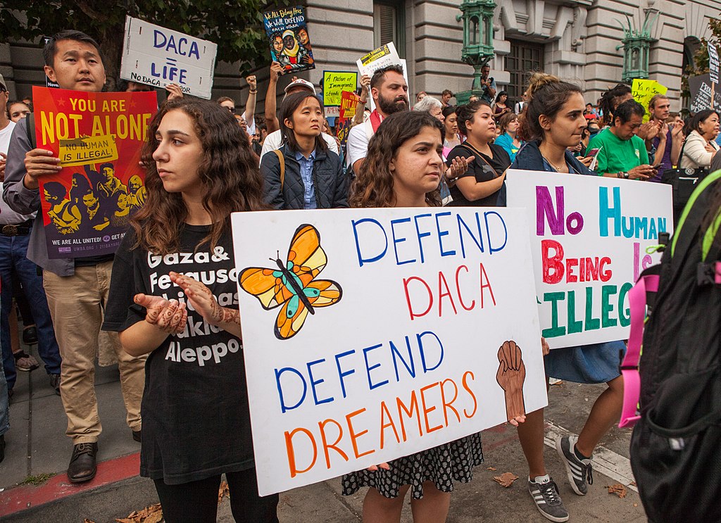 Protesters hold various signs and banners at a DACA rally in San Francisco. Photo by Wikipedia user Pax Ahimsa Gethen