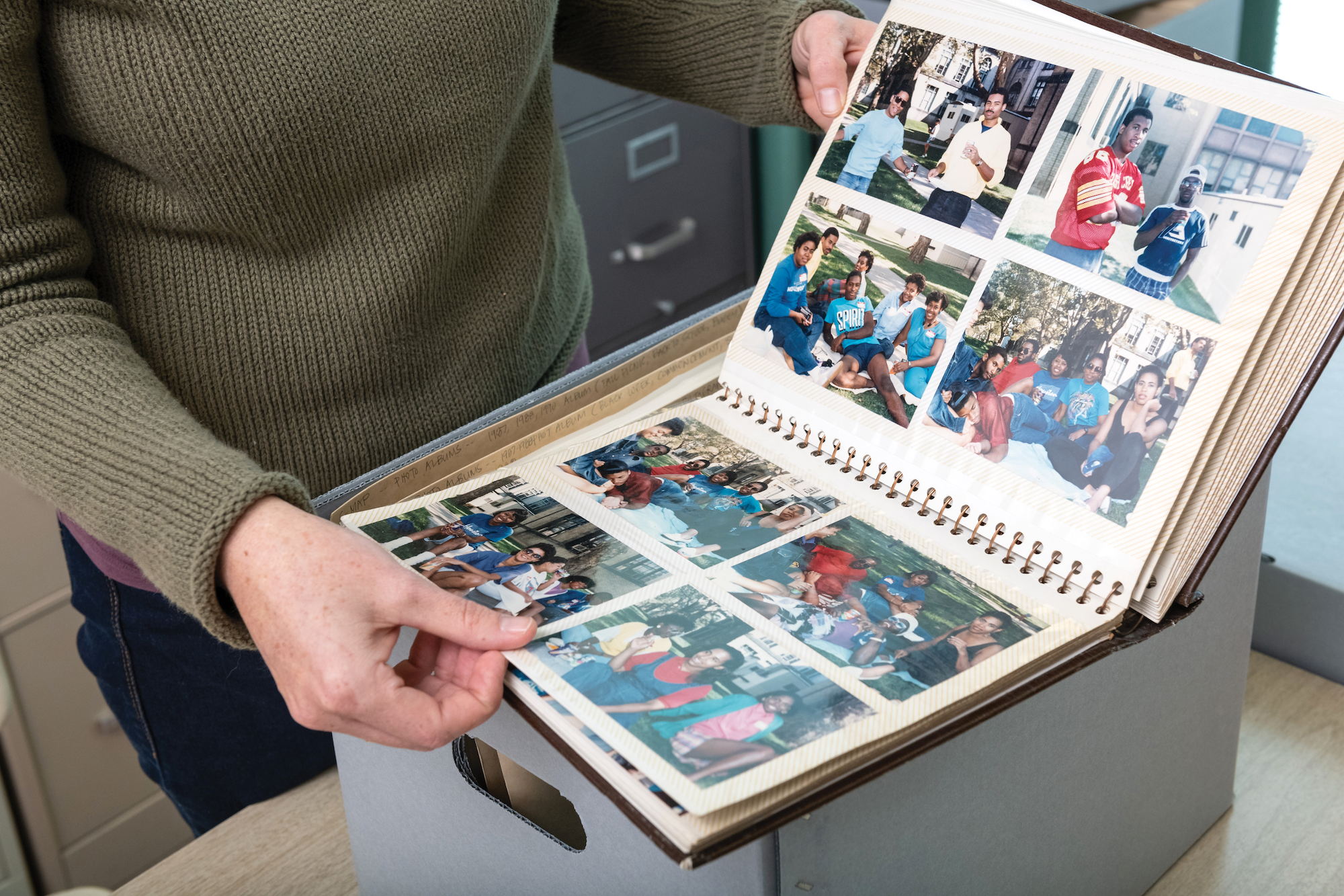 CMU Libraries created a virtual exhibit in 2020 which sought in part to increase its collection of student materials from underrepresented groups. Here, an archivist displays a scrapbook donated to the university’s archives.