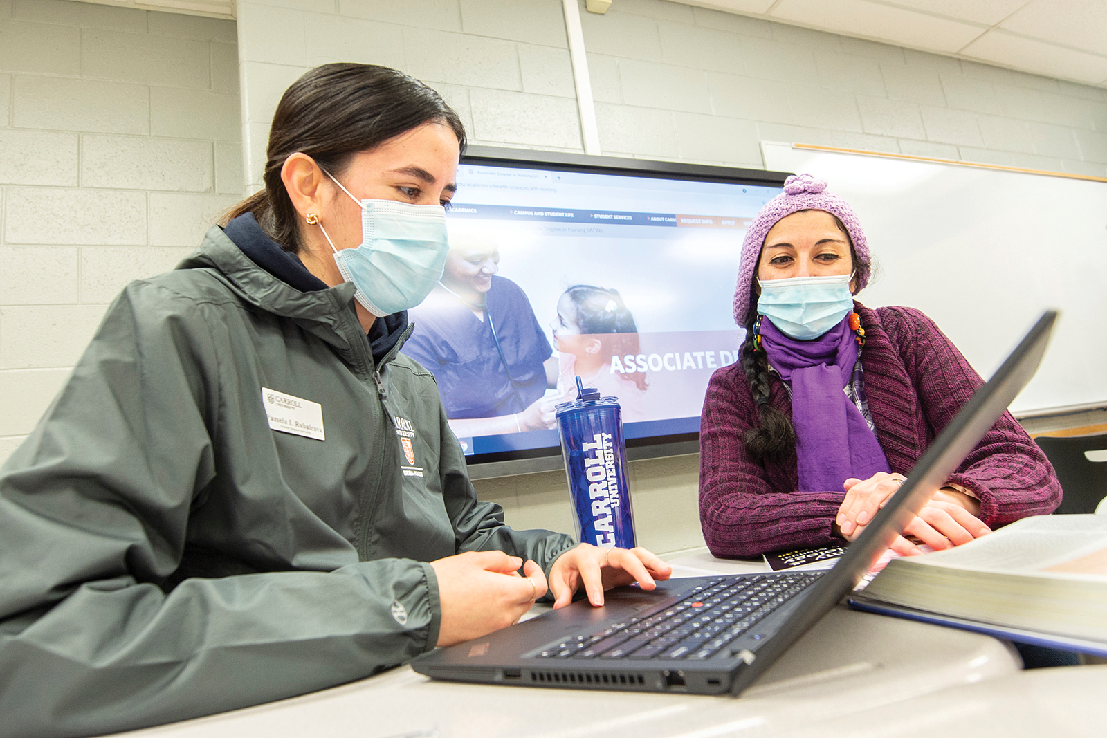 Pamela Rubalcava (left), student support specialist for Carroll University’s ADN program, assists nursing student Veronica Aravena-Salgado.