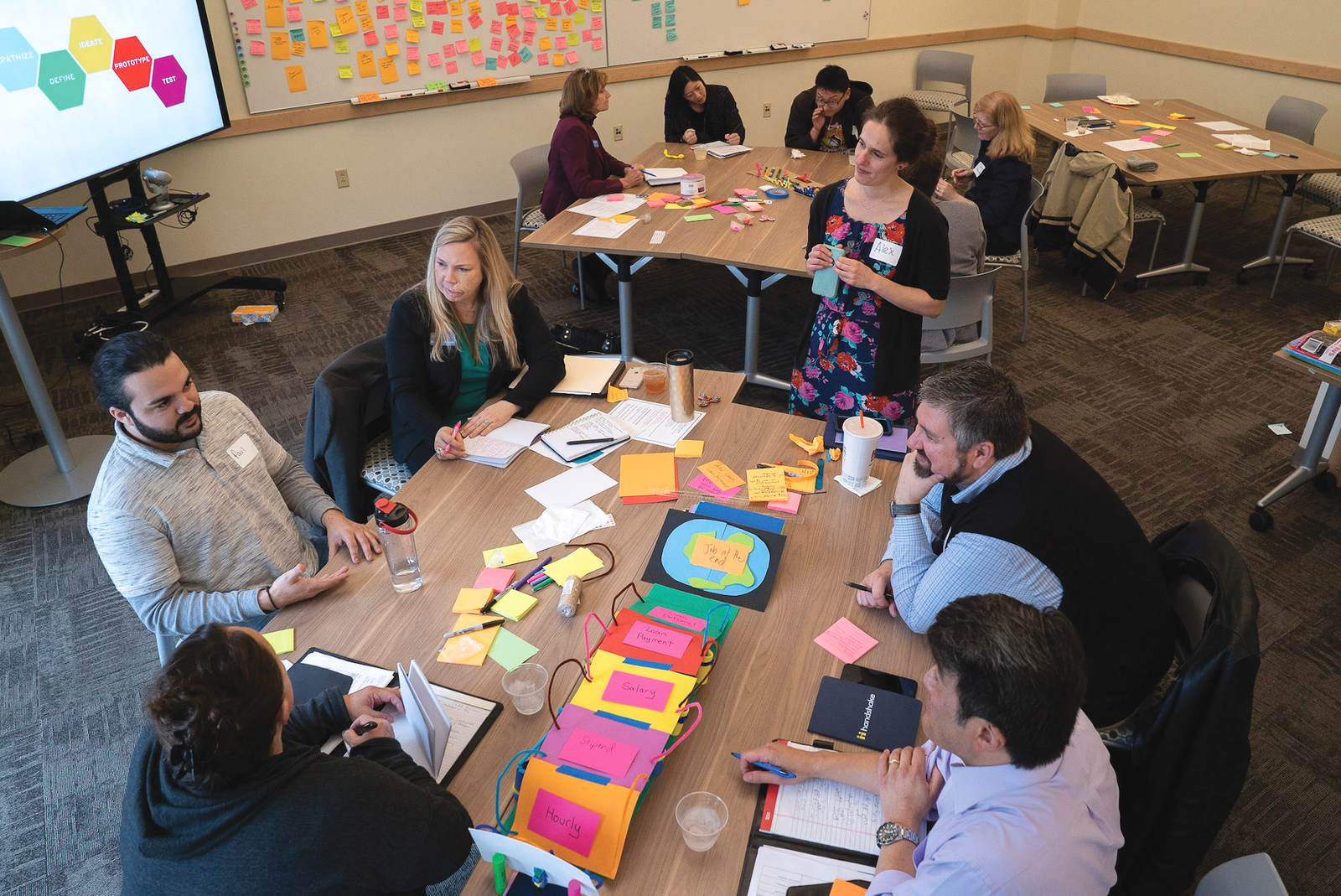 overhead shot of teachers gathered around a roundtable