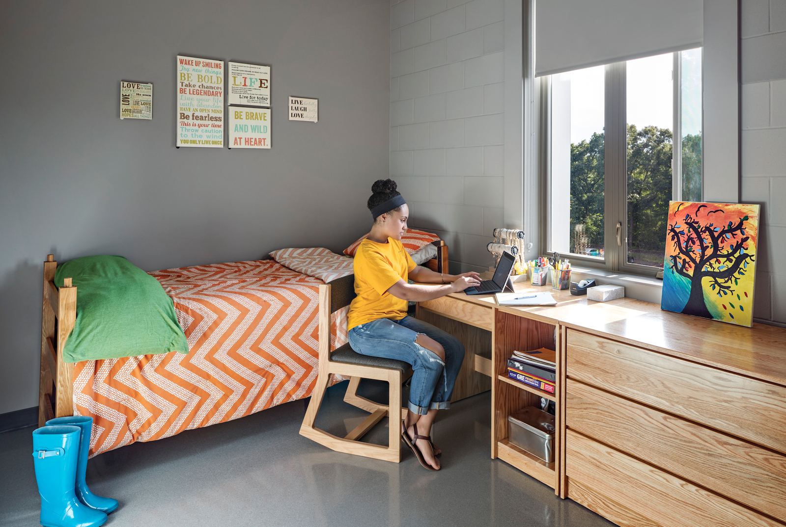 photo of student sitting at desk in dorm room