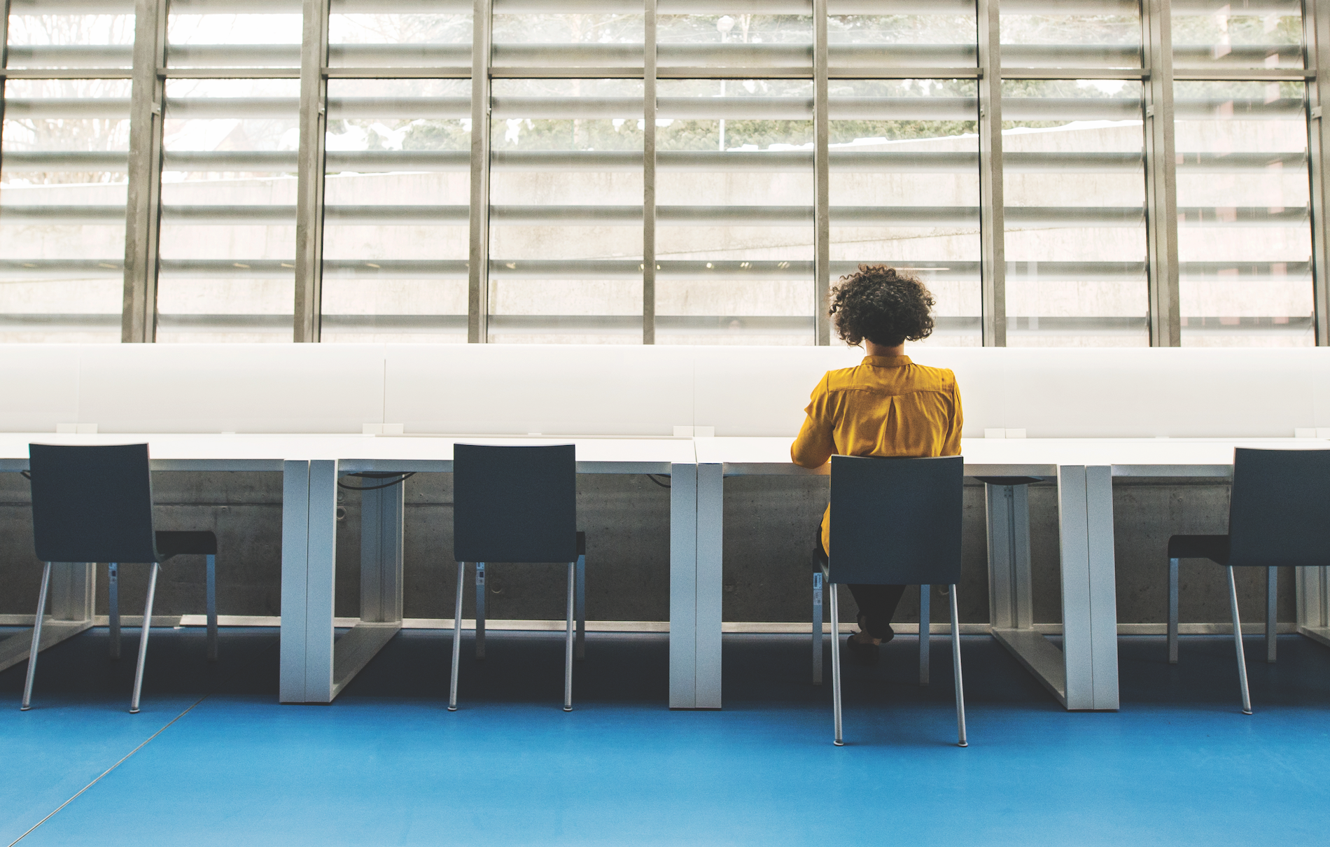 Black woman sits alone at a table