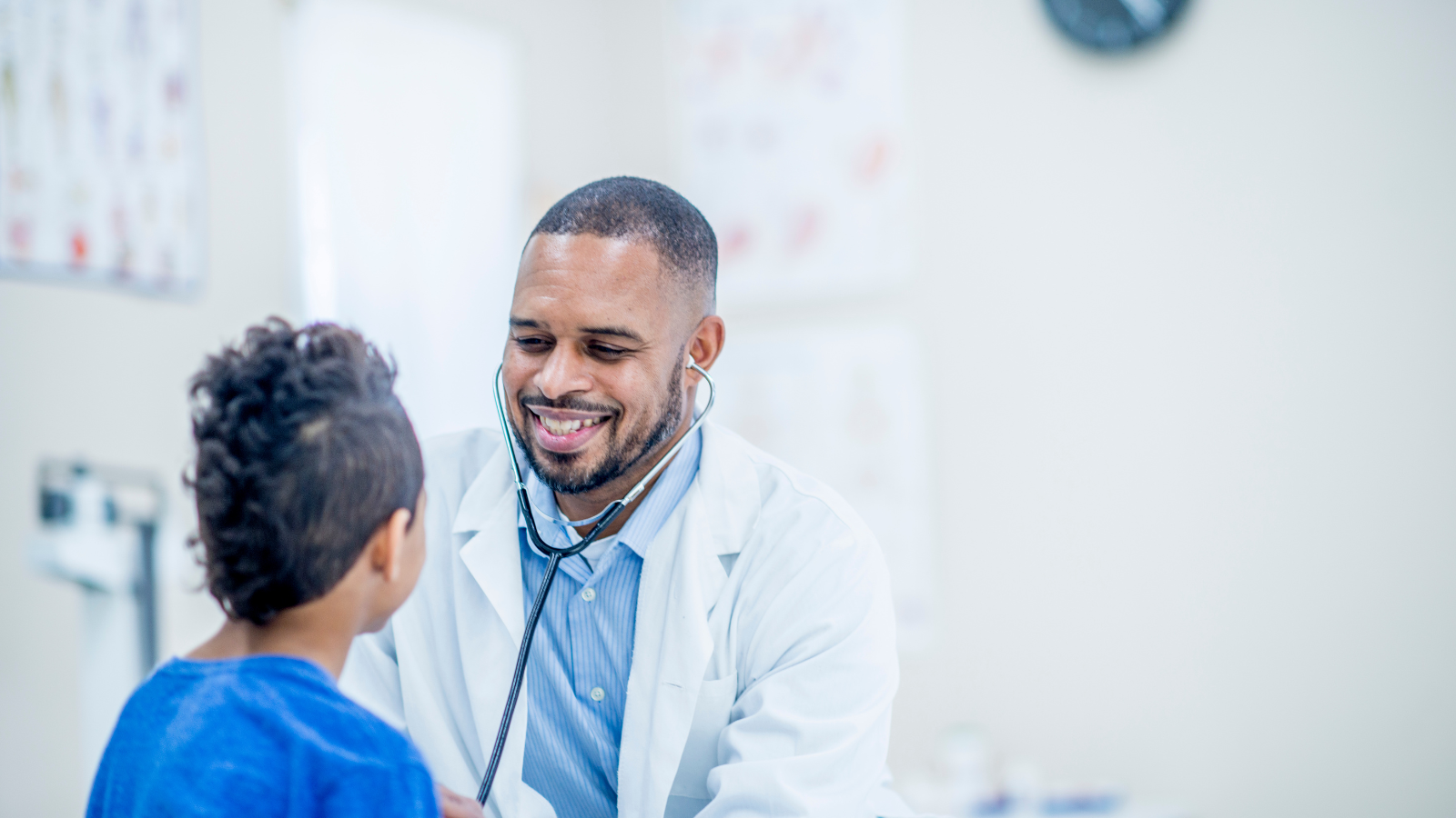 A Black doctor treats a young African American patient. The Community Equity Alliance, a new initiative to eliminate barriers to equitable health care for underserved communities, was announced in January 2023 by CVS Health.