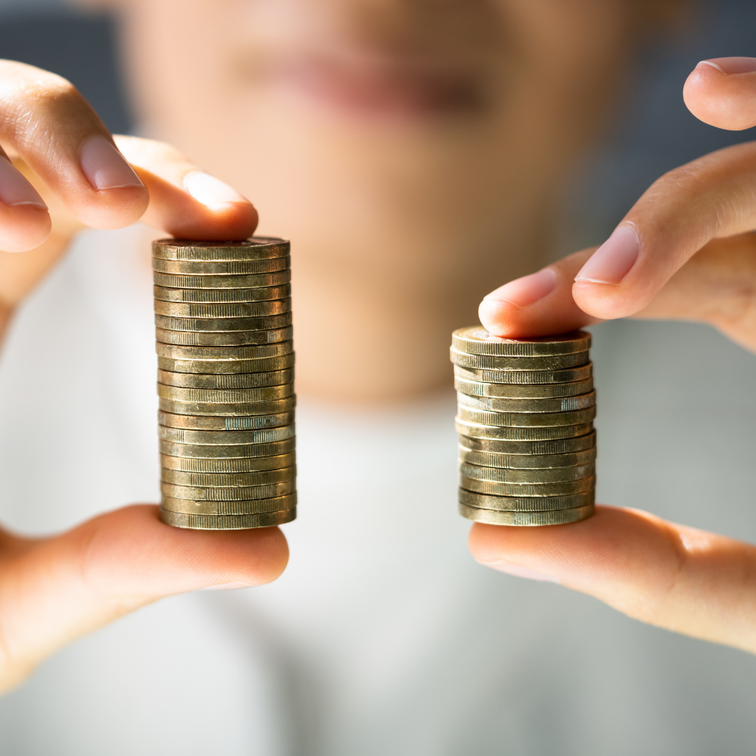 woman holding two uneven stacks of coins