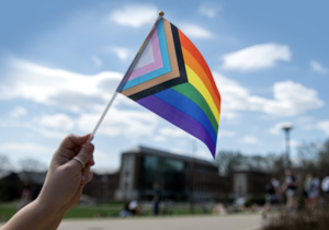 The Progress Pride Flag is held up at the LGBTQ+ Pride March at Pennsylvania State University on April 12, 2023. (Photo courtesy of Patrick Mansell/Penn State)