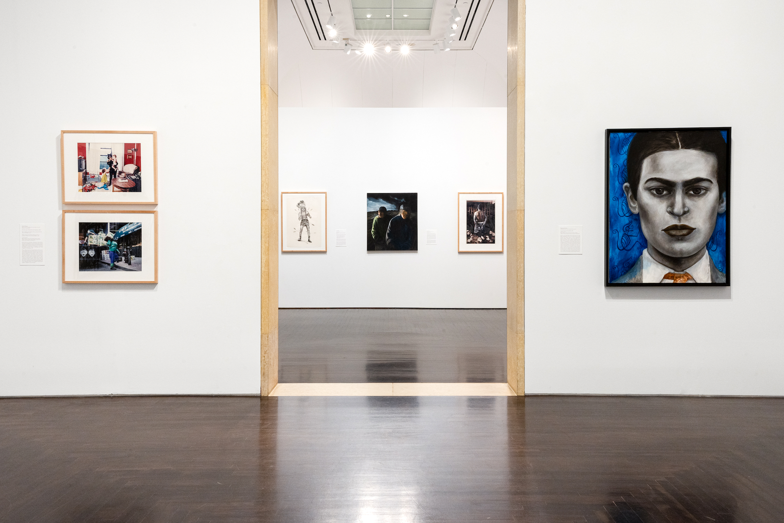 Installation view of the Cara a Cara/Face to Face exhibit, featuring portraits by Chicano Artists from the Gilberto Cárdenas and Dolores Garcia Collection at UT Austin’s Blanton Museum of Art.