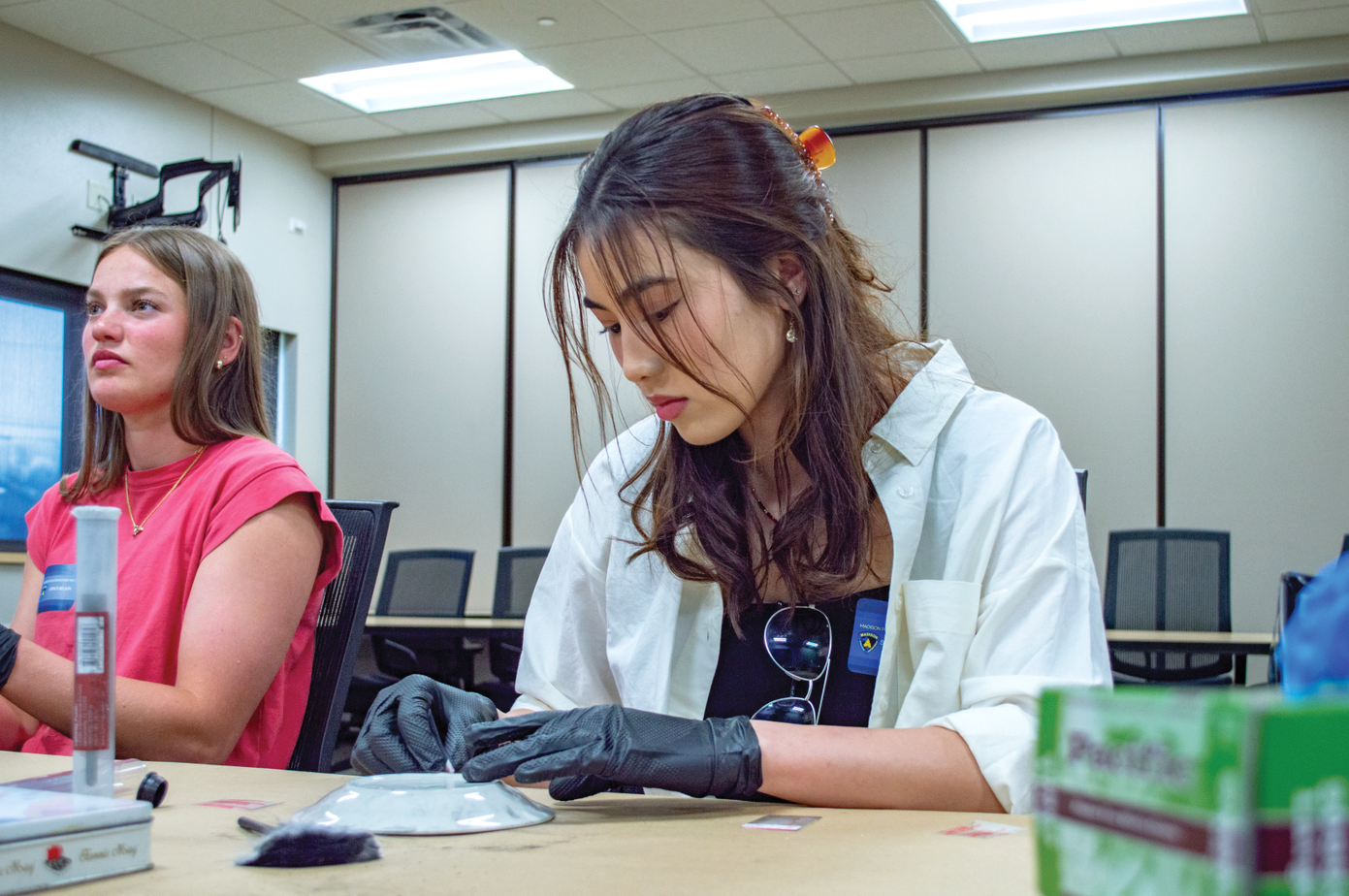 Students participate in a fingerprinting activity during a UW-Women in Criminal Justice Mentoring Program event at the Madison Police Department. (Photo courtesy of the UW-Women in Criminal Justice Mentoring Program)