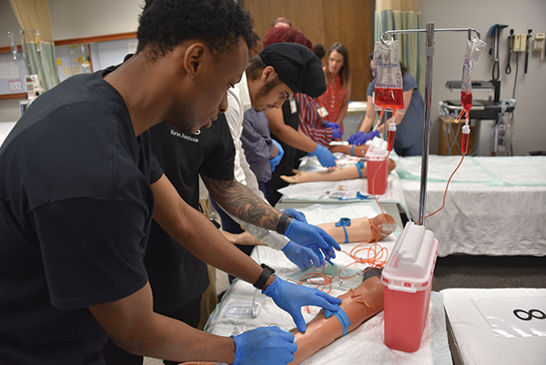 Participants in Health Career University’s Pre-Nursing Summer Scholars program practice blood-draw techniques at the UAMS College of Nursing’s Innovative Practice and Simulation Center. (Photo courtesy of UAMS/Chris Carmody)